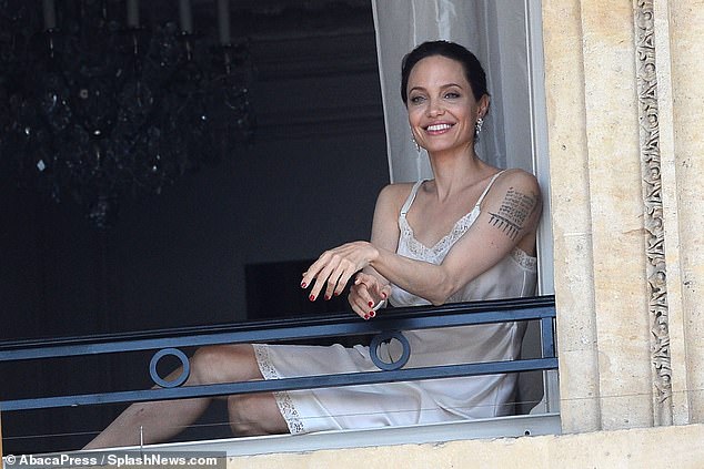 Perfect in Paris: As she reclined on the balcony, the Lara Croft star admired the view overlooking the Eiffel Tower and the stunning cityscape