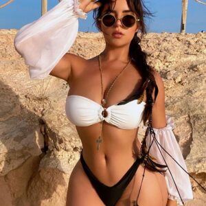 Embracing the allure of Ibiza in timeless black  white. Demi Rose radiates confidence in her stunning beach attire!