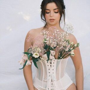 Demi Rose stuns in a captivating pH๏τoshoot, showcasing a white mesh corset and floral themes in Ibiza