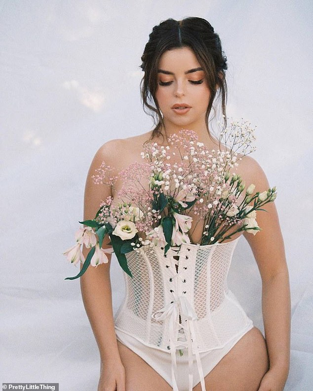 Racy: Demi Rose put on a sizzling display on Instagram on Tuesday as she posed topless in white tie-up corset for a pH๏τoshoot with PrettyLittleThing