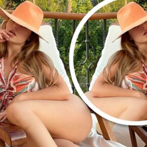 Demi Rose puts on a leggy display in a colourful swimsuit and trilby hat