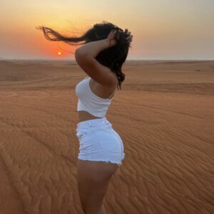 Ameli Olivera radiates beauty under the captivating sunset, her alluring curves effortlessly stealing the spotlight.