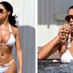 Demi Rose embracing the sun and sand in a stunning white swimsuit, poolside in Cape Verde. Pure paradise.