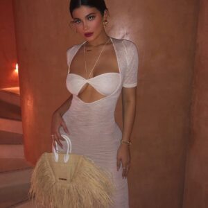 Kylie Jenner stuns in a sheer white gown, showcasing her iconic curves. Confidence looks gorgeous on her!