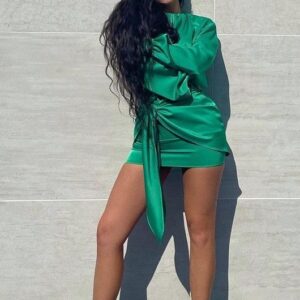 Kylie Jenner’s mesmerizing satin mini dress with emerald detailing is pure perfection, radiating grace and sophistication at every turn.