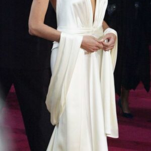 Captivated by Angelina Jolie’s ethereal presence in her stunning ivory ensemble, a true embodiment of elegance that takes our breath away.