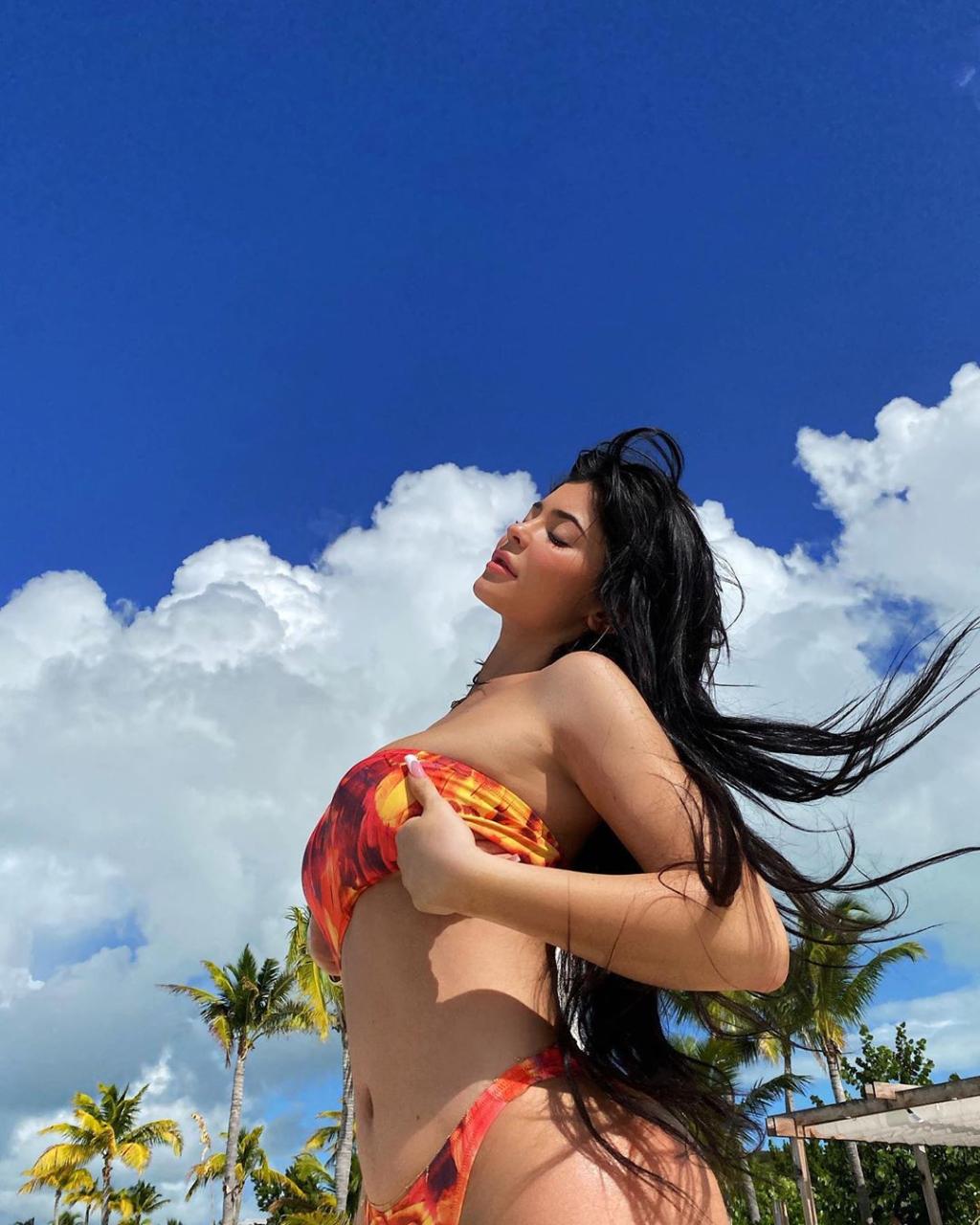  Kylie let her hair down as she posed in front of a blue sky and fluffy white clouds