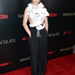 Sydney Sweeney stuns in a bold ensemble next to her grandmothers at the LA premiere of Immaculate, showcasing avantgarde style with grace and familial love. Shine on!