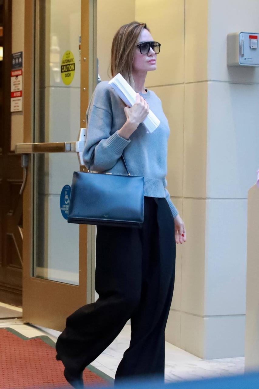 Angelina Jolie shows her elegant style in a grey sweater and black trousers while stopping by a friend's apartment in Los Angeles-190124_7