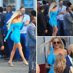 Embracing her curves with confidence, Khloe Kardashian stuns in a bold blue mini dress that accentuates her figure.