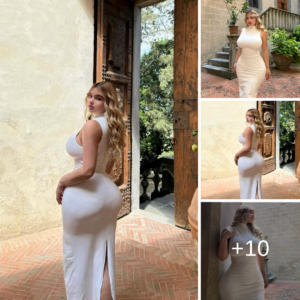 Watch the transformation as Anastasiya Kvitko dazzles in a stunning fitted white dress, embodying elegance and sophistication with every step she takes.