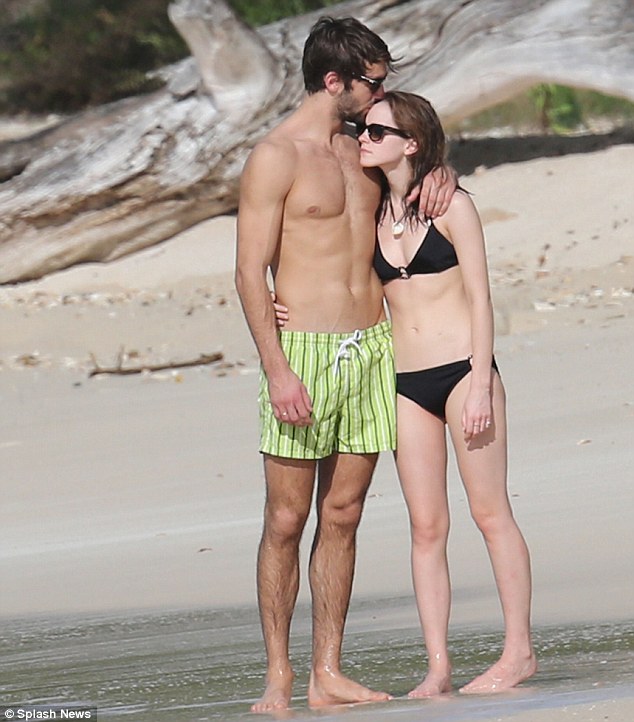 Sealed with a kiss: Emma Watson has now confirmed her rumoured relationship with Oxford University student Matt Janney as the pair put on a rather amorous display on a Caribbean beach