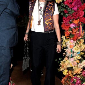 Miley Cyrus looks cool in a colorful vest and Chanel necklace as she leaves Gymkhana restaurant